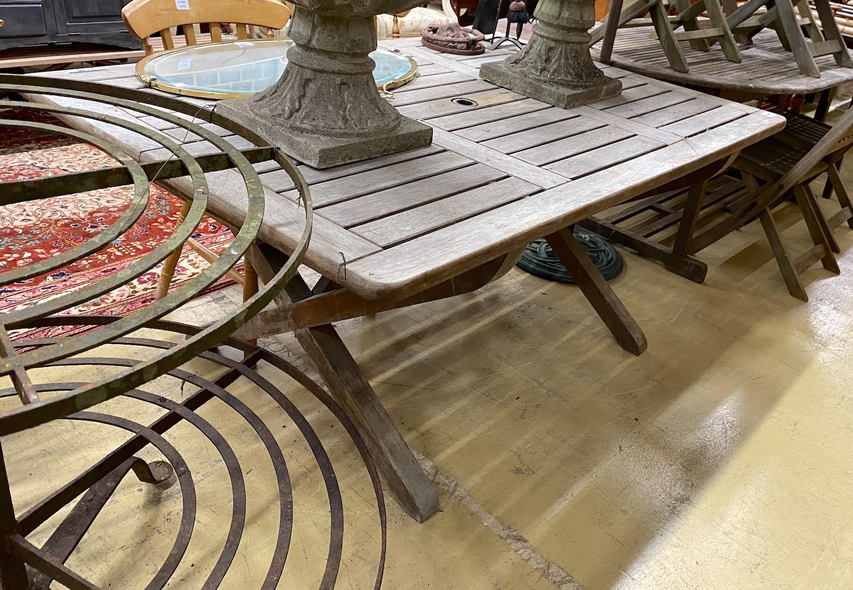 A weathered teak rectangular topped garden table, length 162cm, height 111cm